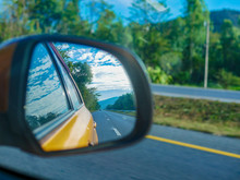Highway Road Reflection On Car Side Mirror Use For Car Driving Insurance Concept 