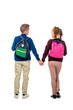 © LIGHTFIELD STUDIOS - back view of children holding hands with multicolored backpacks isolated on white