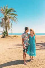 Wall Mural - Lovers man and woman on the sea with palm trees. Selective focus.