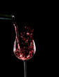 Pouring red wine, wine bottle and wineglass