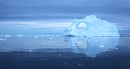 Wall Mural - photogenic and intricate iceberg under an interesting and colorful sky during sunset. disko bay, gre