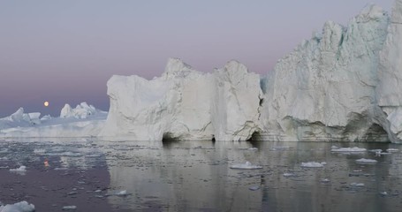 Wall Mural - photogenic and intricate iceberg under an interesting and colorful sky during sunset. disko bay, gre
