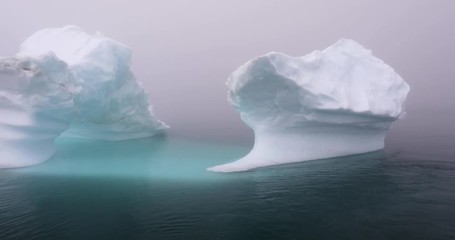 Wall Mural - photogenic and intricate iceberg under an interesting and colorful sky during sunset. disko bay, gre