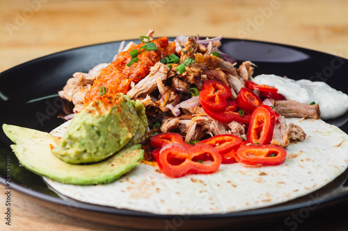 Fotografia, Obraz Unwrapped burrito in plate on wooden table