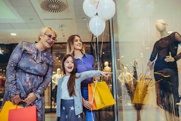 Wall Mural - Mother, adult daughter and granddaughter in shopping mall together