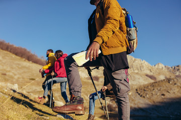 Wall Mural - Group of hikers walking on a mountain at autumn day