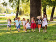 © Evgeniy Kalinovskiy - a group of preschoolers running on the grass in the Park. The concept of ethnic friendship, peace, childhood, kindness.