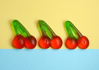 Wall Mural - jelly cherry's. Minimal concept. Colorful Party background. Jelly fruit jelly on bright background. Studio Photo. Flat lay.