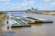 River barges docked along the shoreline of the Illinois River in Peoria Illinois. 