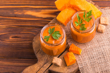 Wall Mural - Fresh pumpkin smoothie in glass jar with parsley