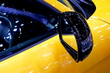 Close Up Of Car Side Mirror And Technical Part Of Modern Sport Automotive Yellow Car