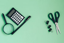 Different Black Stationery On A Green Background. Top View, Flat Lay