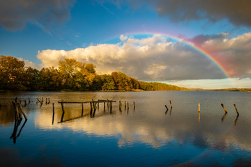 Wall Mural - rainbow over the lake on an autumn evening