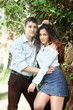 © soleg - young couple walking in the forest, posing near tree, summer nature, bright sunlight, shadows and green leaves, romantic feelings