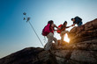 © Natnan - Hikers walking with backpack on a mountain at sunset. traveler going camping. travel concept.
