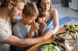 © Pixel-Shot - Family praying before meal at home