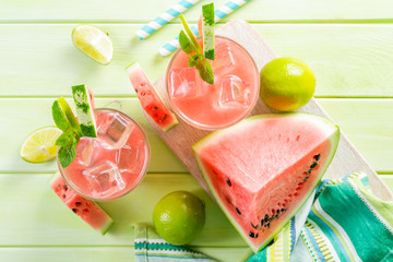 Wall Mural - Watermelon lemonade with lime and mint, wood background, copy space