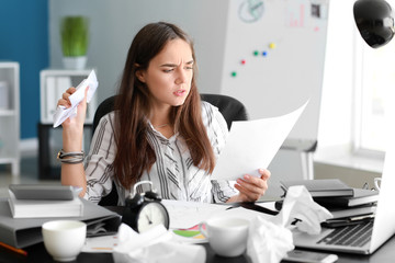 Stressed businesswoman trying to meet deadline in office