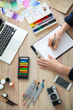 Young designer working at wooden table