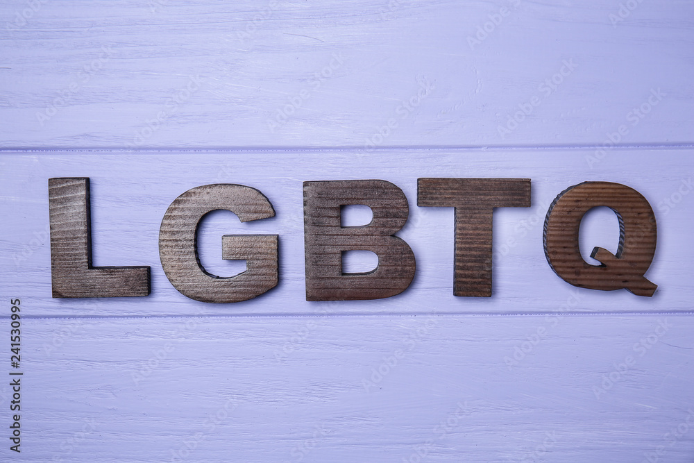 Abbreviation LGBTQ on wooden background