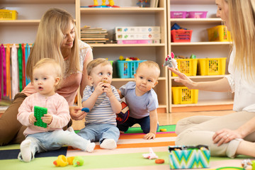 Babies is playing in nursery. Children in the daycare center. Fun in the children's playroom