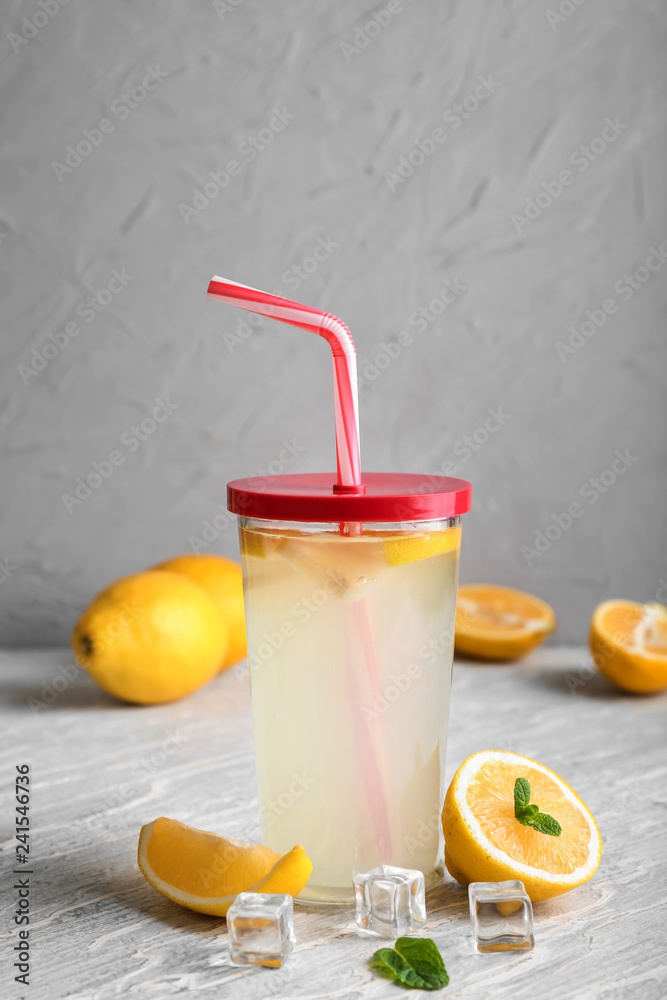 Glass of fresh lemonade on table