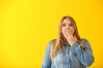 Wall Mural - Surprised plus size girl on color background. Concept of body positivity