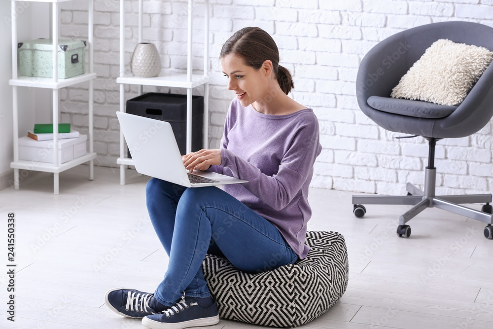 Young woman working with laptop at home