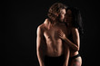 © Pixel-Shot - Passionate young couple on dark background