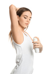 Poster - Beautiful young woman with deodorant on white background