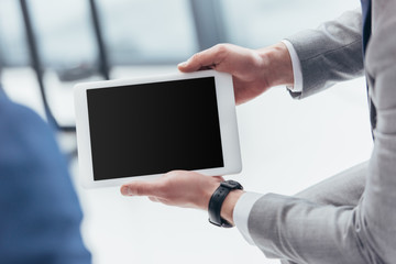 Wall Mural - partial view of businessman holding digital tablet with blank screen