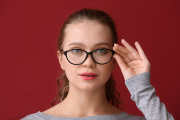 Wall Mural - Portrait of woman with bad sight on color background