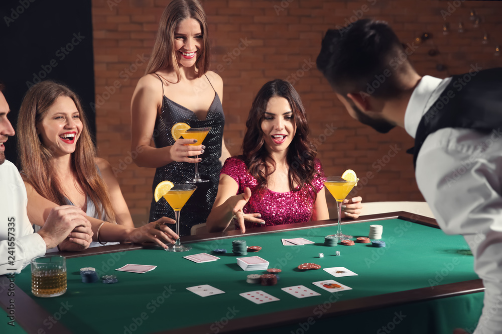 Group of people playing poker in casino