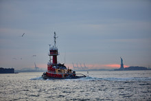 Fishing Boat In The Sea, With Liberty Statue On Background