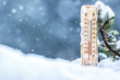 Thermometer on snow shows low temperatures in celsius or farenheit