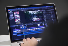 Video Editing With Laptop. Professional Editor Adding Special Effects Or Color Grading Footage For Commercial Film Or Movie.