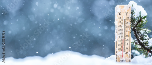Fotografía Thermometer on snow shows low temperatures in celsius or farenheit