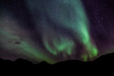 Fototapeta Tulipany - Amazing Aurora Borealis in North Norway (Kvaloya), mountains in the background