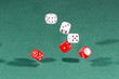 © Kruwt - Six red and white dices falling on a green table