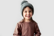 © Z A C - Cute happy little girl in the winter warm gray hat, wearing sweater posing on a white studio background.