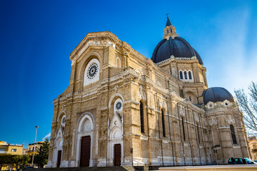 Cathedral of San Pietro Apostolo, also known as Duomo Tonti, by Paolo Tonti, who donated his wealth for its construction. Facade, rose windows, portals, dome and apse. Cerignola, Puglia, Italy.