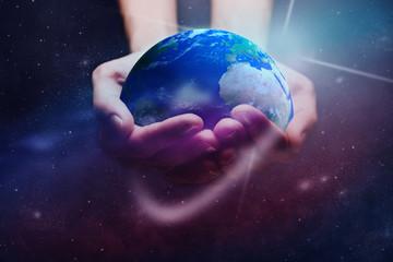 Leinwandbilder - Protect our world in human hands and nebula dust. Mixed media .Elements of this image furnished by NASA.