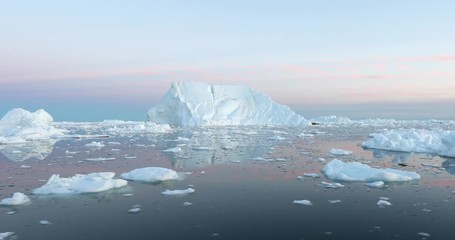 Wall Mural - photogenic and intricate iceberg under an interesting and colorful sky during sunset. disko bay, gre