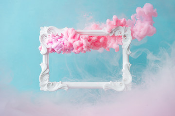 Wall Mural - White vintage frame on pastel blue background with abstract pink cloud shapes. Minimal border composition.