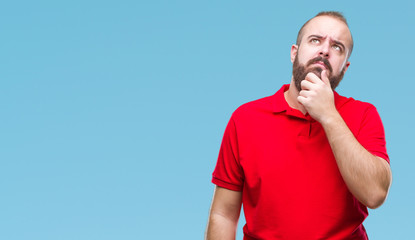 Sticker - Young caucasian hipster man wearing red shirt over isolated background with hand on chin thinking about question, pensive expression. Smiling with thoughtful face. Doubt concept.