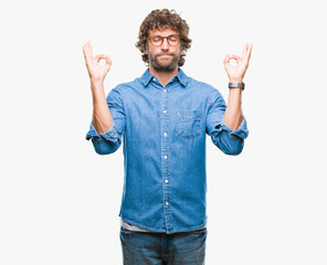 Sticker - Handsome hispanic model man wearing glasses over isolated background relax and smiling with eyes closed doing meditation gesture with fingers. Yoga concept.