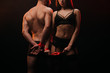 cropped view of passionate couple with red ribbon in smoky room