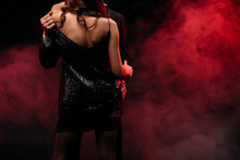 Back View Of Sexy Couple Hugging In Red Smoky Room