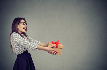 Cheerful woman giving Xmas present