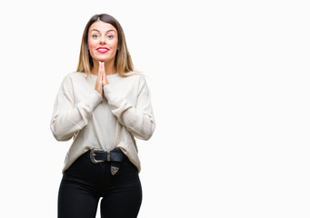 Poster - Young beautiful woman casual white sweater over isolated background praying with hands together asking for forgiveness smiling confident.